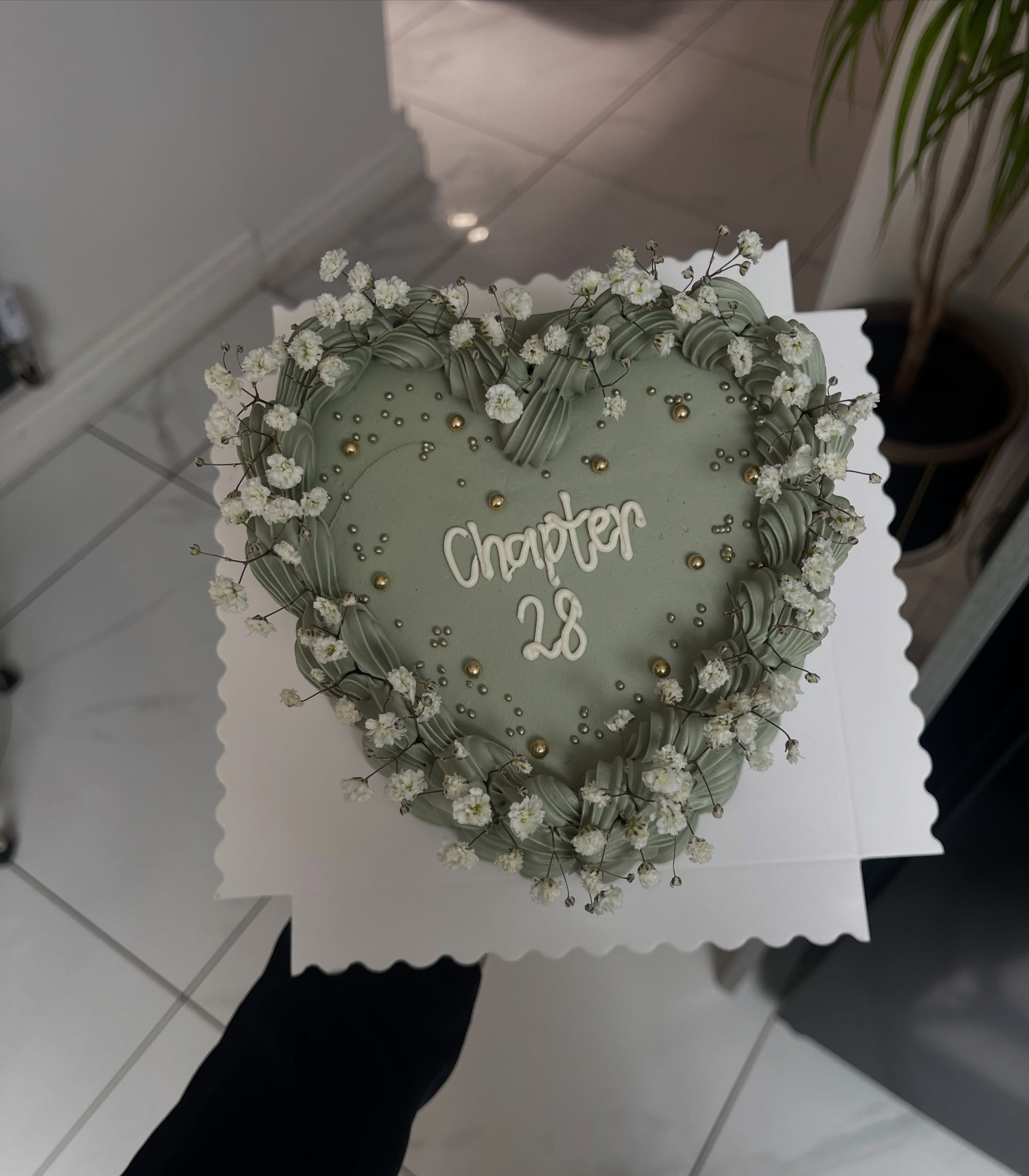 Sage green heart cake with baby's breath