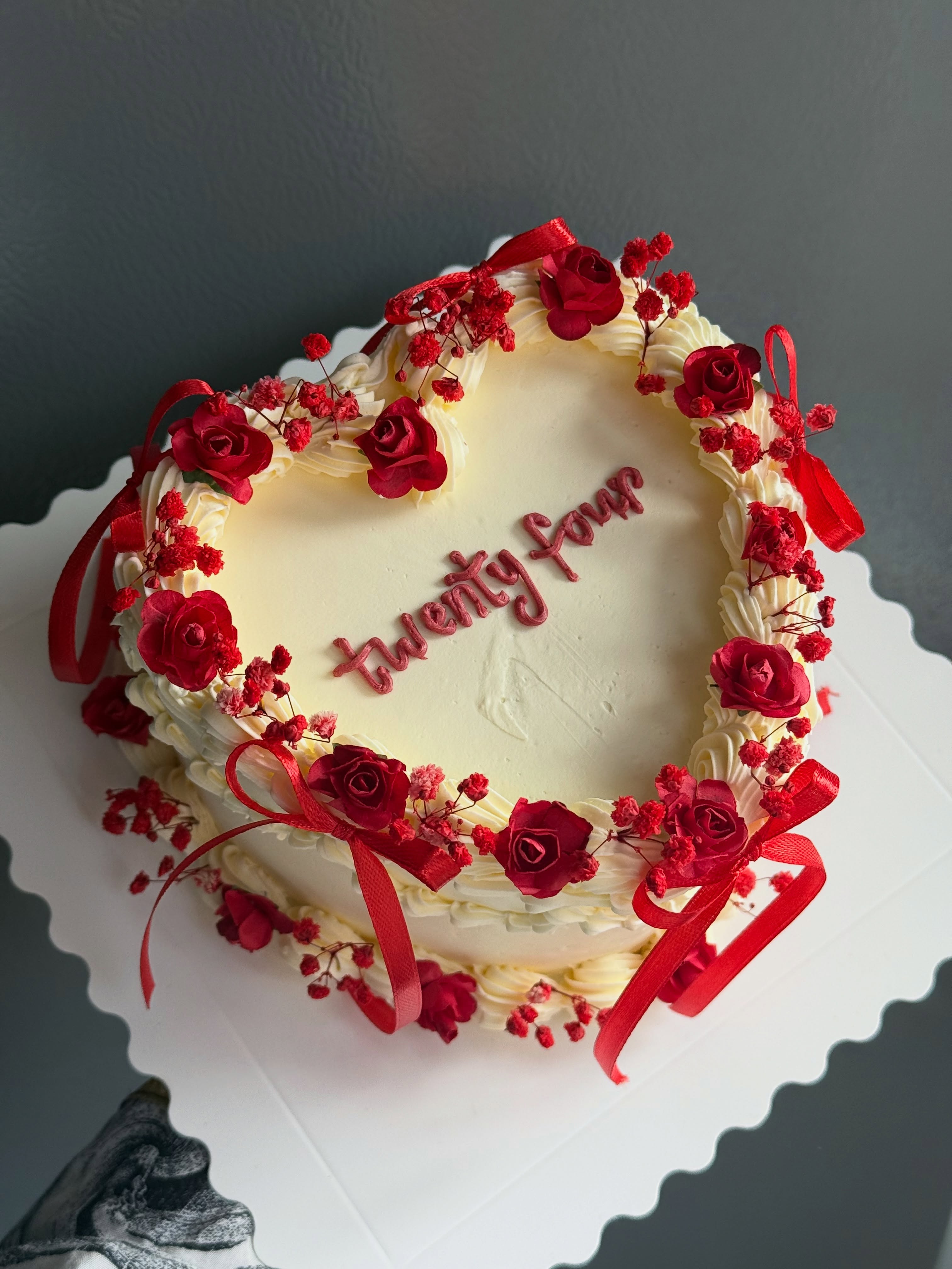 Cream heart cake with red roses and piped message