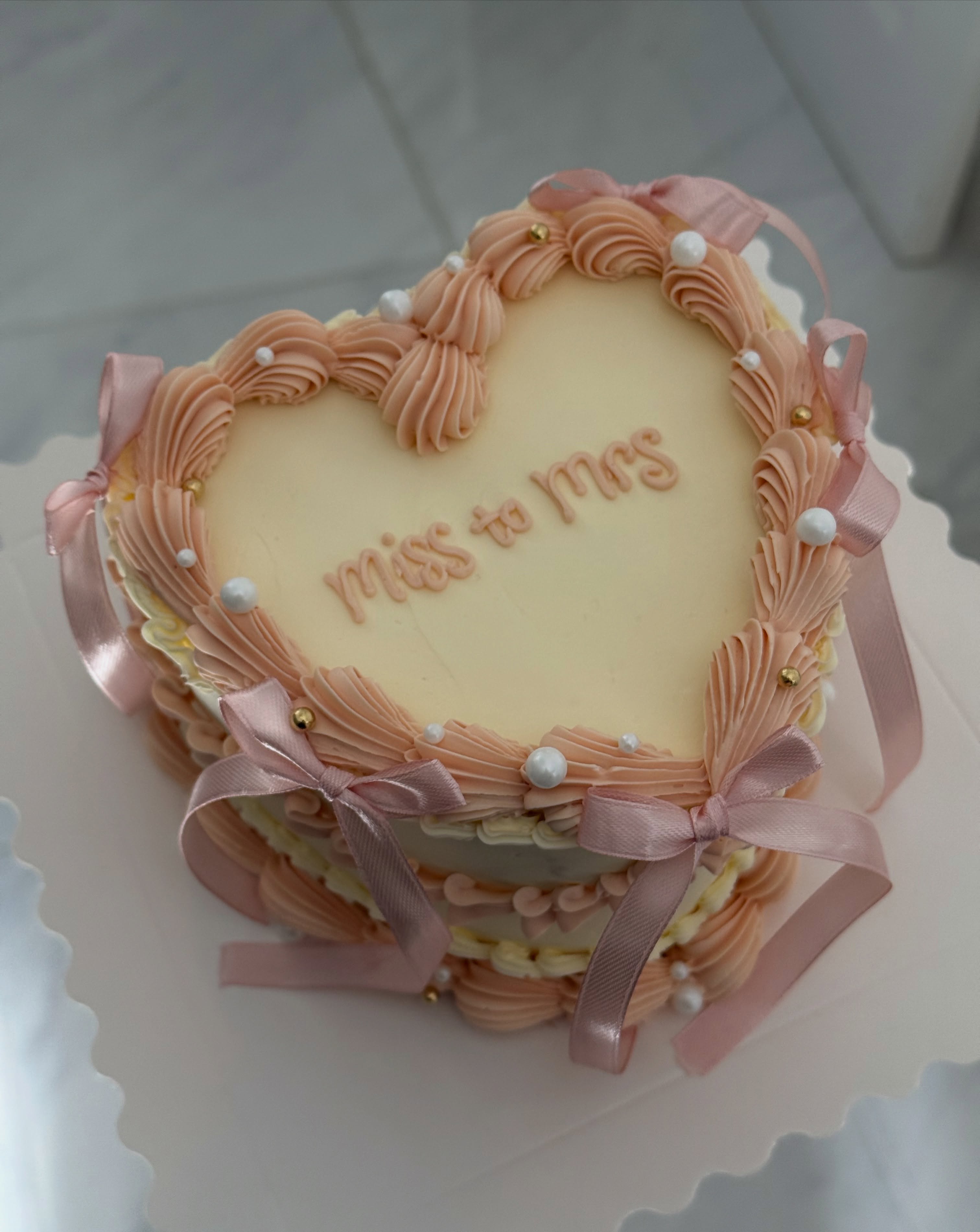 Blush heart cake with bow details
